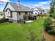 Sprawling backyard featuring a patio area, outdoor furniture, play set, and ample green space at 538 Mulberry Fern Dr, Auburn, GA 30011