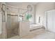Luxurious bathroom featuring shower, garden tub, tile accents, and neutral decor at 538 Mulberry Fern Dr, Auburn, GA 30011