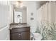 Bathroom featuring a vanity, granite countertop, decorative shower curtain and floral accents at 538 Mulberry Fern Dr, Auburn, GA 30011