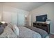 Bedroom featuring a patterned comforter, TV, closet, and neutral wall colors at 538 Mulberry Fern Dr, Auburn, GA 30011