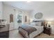 Cozy bedroom featuring a queen bed, neutral walls, and ample natural light from the window at 538 Mulberry Fern Dr, Auburn, GA 30011