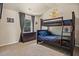 bedroom featuring a carpeted floor, painted walls, a window, a bunk bed, and a dresser at 538 Mulberry Fern Dr, Auburn, GA 30011