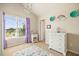 Bright bedroom with a large window providing ample natural light and a soft, colorful rug at 538 Mulberry Fern Dr, Auburn, GA 30011