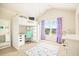 A cozy bedroom featuring an elevated bed, a desk, and natural light from the window at 538 Mulberry Fern Dr, Auburn, GA 30011
