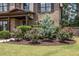 Beautifully landscaped front yard featuring blooming flowers, shrubs, and a well-maintained lawn at 538 Mulberry Fern Dr, Auburn, GA 30011
