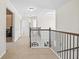 An interior hallway featuring carpet flooring, white walls, and an iron railing at 538 Mulberry Fern Dr, Auburn, GA 30011