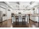 Bright and modern kitchen featuring white cabinets, granite countertops, and a large center island with seating at 538 Mulberry Fern Dr, Auburn, GA 30011