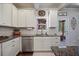 Well lit kitchen featuring white cabinets, stainless steel appliances, and granite countertops at 538 Mulberry Fern Dr, Auburn, GA 30011
