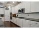 Kitchen with white cabinets, granite countertops, stainless steel oven and microwave at 538 Mulberry Fern Dr, Auburn, GA 30011