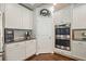 Kitchen featuring white cabinets, granite countertops, and stainless steel appliances at 538 Mulberry Fern Dr, Auburn, GA 30011