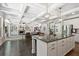 Open-concept living room with hardwood floors, granite island, and stainless steel refrigerator at 538 Mulberry Fern Dr, Auburn, GA 30011
