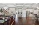 Open-concept living room with hardwood floors, beamed ceilings, and a view of the kitchen at 538 Mulberry Fern Dr, Auburn, GA 30011