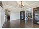 Elegant living room with hardwood floors, coffered ceilings, and stylish bookcases for storage and display at 538 Mulberry Fern Dr, Auburn, GA 30011