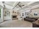 Spacious living room with a brick fireplace, built-in shelves, and coffered ceiling at 538 Mulberry Fern Dr, Auburn, GA 30011