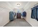 Walk-in closet featuring neutral walls, carpet, and shelving for ample storage at 538 Mulberry Fern Dr, Auburn, GA 30011