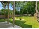 Lush backyard offers a peaceful outdoor space with mature trees and a wood fence at 833 Humphries Sw St, Atlanta, GA 30310