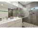 Modern bathroom with double vanity, gray tiled shower, and hexagon tile floor at 833 Humphries Sw St, Atlanta, GA 30310