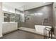 Modern bathroom with a free-standing tub and glass-enclosed shower with gray tiling at 833 Humphries Sw St, Atlanta, GA 30310