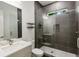 Modern bathroom featuring a glass shower, gray tiling, and white hexagonal tile flooring at 833 Humphries Sw St, Atlanta, GA 30310