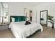 Inviting bedroom with modern decor, stylish mirrors, plants, comfortable bed, and green accents at 833 Humphries Sw St, Atlanta, GA 30310