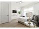 Bright bedroom with neutral decor, large window, sheer curtains, and a ceiling fan at 833 Humphries Sw St, Atlanta, GA 30310