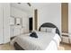 Bright bedroom with white walls, stylish mirrors, wood accents, and a comfortable bed topped with fresh linens at 833 Humphries Sw St, Atlanta, GA 30310