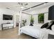 Cozy bedroom featuring a canopy bed, hardwood floors, and a modern ceiling fan at 833 Humphries Sw St, Atlanta, GA 30310