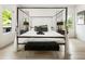 Bright bedroom with a canopy bed, windows, and hardwood floors at 833 Humphries Sw St, Atlanta, GA 30310