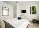 Bedroom featuring a large bed with modern decor, hardwood floors, and a mounted TV at 833 Humphries Sw St, Atlanta, GA 30310