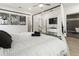 Modern bedroom with a canopy bed, TV, and an open doorway to the bathroom at 833 Humphries Sw St, Atlanta, GA 30310