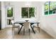 Bright dining area with a modern table, chairs, and large windows offering a view of nature at 833 Humphries Sw St, Atlanta, GA 30310