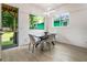 Open concept dining area features a modern table and chairs with view of the backyard at 833 Humphries Sw St, Atlanta, GA 30310
