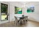 Dining area with backyard view, featuring a modern table with chairs, hardwood floors, and backyard access at 833 Humphries Sw St, Atlanta, GA 30310
