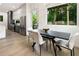 Dining area with modern table and chairs, hardwood floors, and a view of the backyard at 833 Humphries Sw St, Atlanta, GA 30310