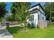 Side view of the modern home displaying a lush lawn and wood fence at 833 Humphries Sw St, Atlanta, GA 30310