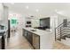 Open-concept kitchen with a large island, stainless steel appliances, and stylish design at 833 Humphries Sw St, Atlanta, GA 30310