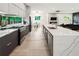 Open-concept kitchen with gas range, stainless appliances, and expansive island facing living area at 833 Humphries Sw St, Atlanta, GA 30310