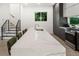 Bright kitchen showcasing a marble island with seating, stainless steel appliances, and hardwood floors at 833 Humphries Sw St, Atlanta, GA 30310
