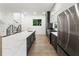 Modern kitchen featuring a large marble island, stainless steel appliances, and sleek gray cabinets at 833 Humphries Sw St, Atlanta, GA 30310