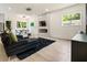 Bright, open living room featuring a modern fireplace, sleek furniture, and light wood floors at 833 Humphries Sw St, Atlanta, GA 30310