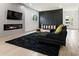 Living room with a modern fireplace, dark accent wall, and plush rug at 833 Humphries Sw St, Atlanta, GA 30310