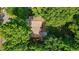 Overhead view of a home with a brown roof partially obscured by tall trees at 340 Windsor Se Walk, Conyers, GA 30094