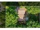 Aerial view of a home with a brown roof surrounded by lush green trees in a suburban neighborhood at 340 Windsor Se Walk, Conyers, GA 30094