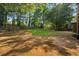 Large backyard with grassy area, wood fence perimeter, and mature shade trees at 340 Windsor Se Walk, Conyers, GA 30094