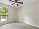 Bedroom with neutral walls, large window, carpet, and ceiling fan at 340 Windsor Se Walk, Conyers, GA 30094