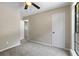 Bedroom with neutral walls, large window, carpet, ceiling fan and two doors at 340 Windsor Se Walk, Conyers, GA 30094
