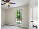 Bedroom with neutral walls, a large window, carpet, and ceiling fan at 340 Windsor Se Walk, Conyers, GA 30094