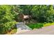 Exterior view of a two-story home with a long driveway and green lawn surrounded by mature shade trees at 340 Windsor Se Walk, Conyers, GA 30094