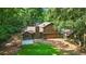 View of the rear exterior of the home, with back porch and trees at 340 Windsor Se Walk, Conyers, GA 30094