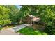 Charming exterior view of a two-story home with a long driveway and lush green lawn at 340 Windsor Se Walk, Conyers, GA 30094